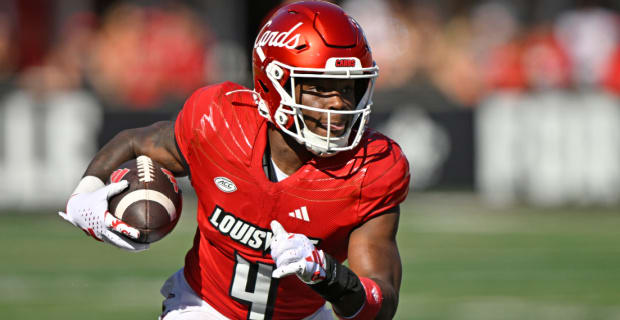 Louisville Cardinals running back Maurice Turner, Jr. on a rushing attempt during a college football game in the ACC.